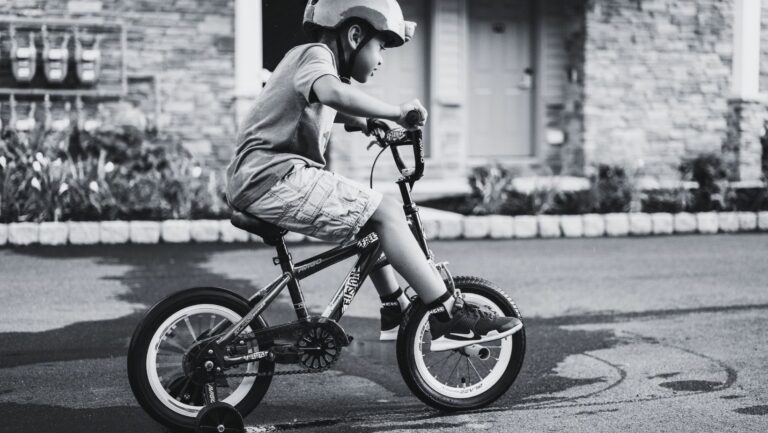 Child riding a bike in the street before an accident