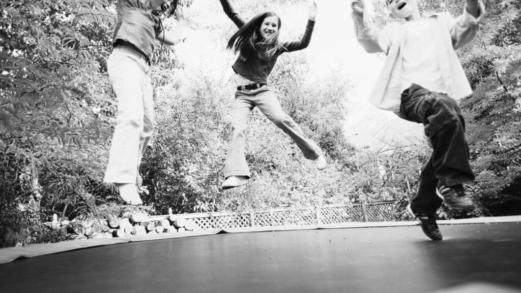 children on a trampoline before an accident