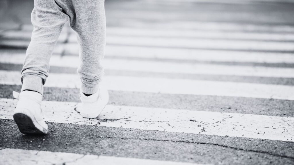 child walking in a crosswalk